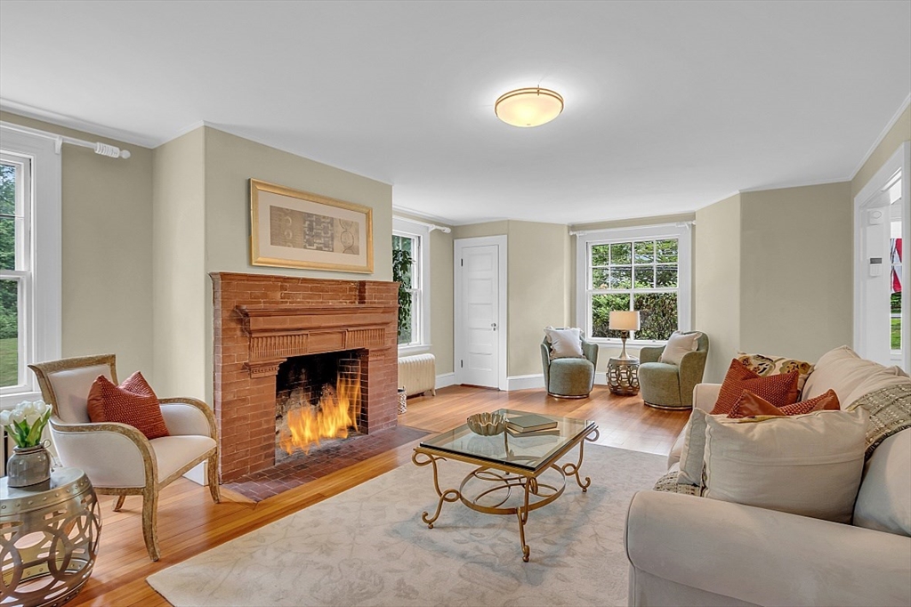 24 Sandy Pond Road Lincoln, MA 01773 - Photo 5 of 42 a living room with furniture and a fireplace
