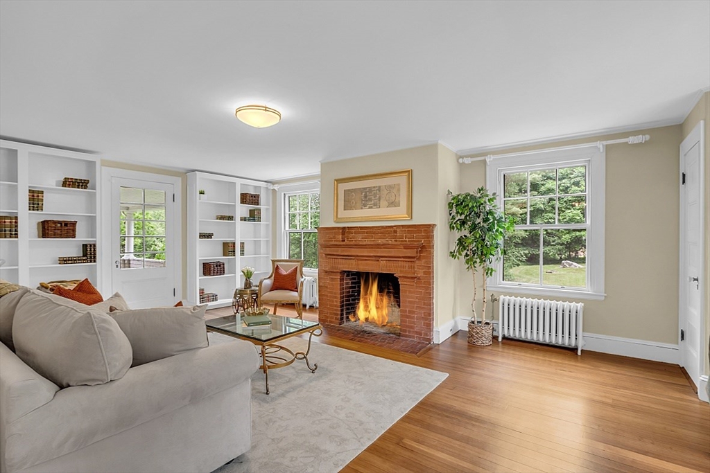 24 Sandy Pond Road Lincoln, MA 01773 - Photo 6 of 42 a living room with furniture and a fireplace