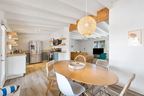 a kitchen with a dining table and chairs