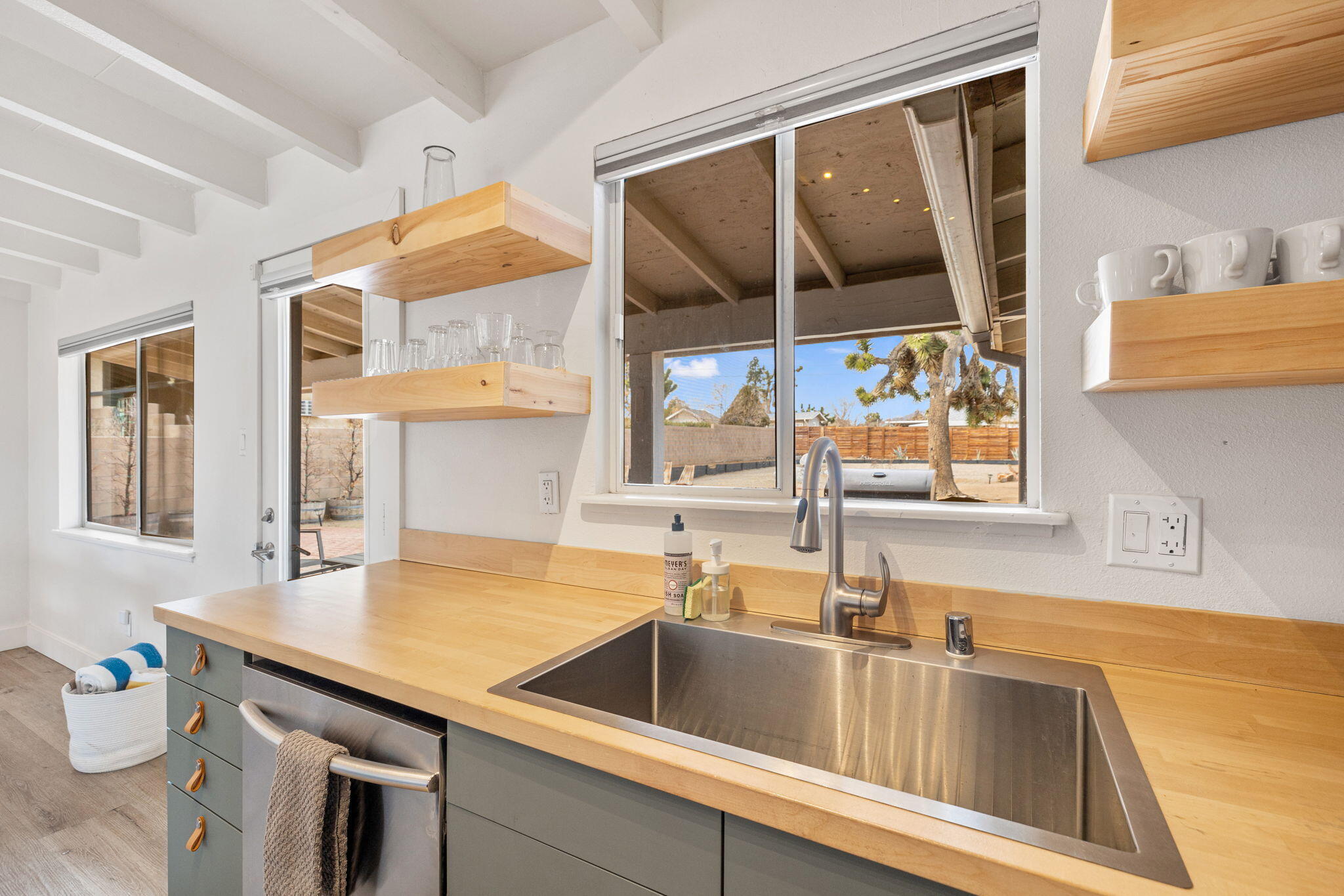7552 Elk Trail Yucca Valley, CA 92284 - Photo 14 of 48 a kitchen with a sink and a refrigerator a mirror
