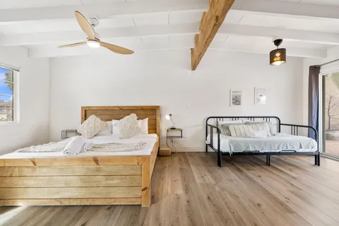 a bedroom with bed and window