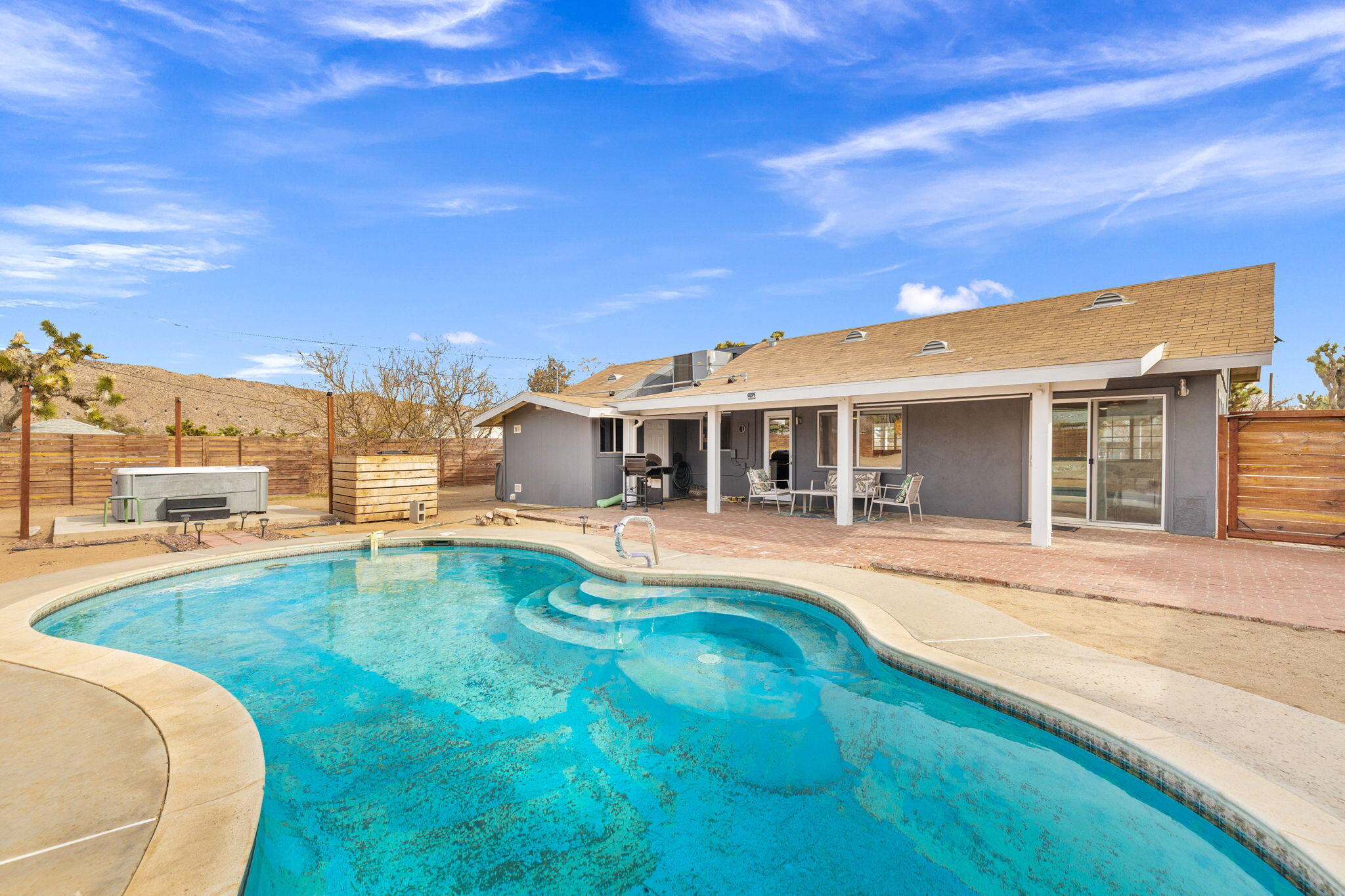 7552 Elk Trail Yucca Valley, CA 92284 - Photo 31 of 48 a view of a house with swimming pool and a yard