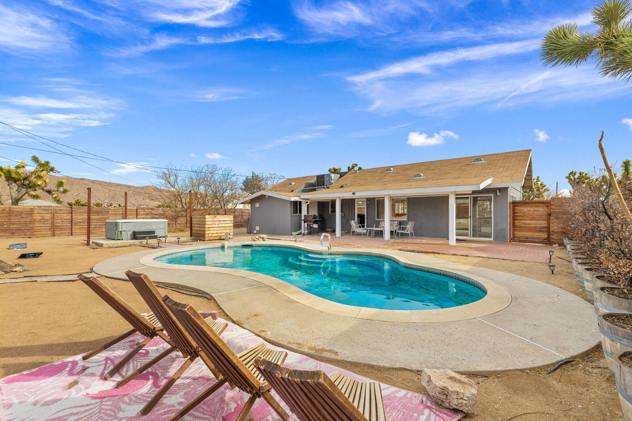 7552 Elk Trail Yucca Valley, CA 92284 - Photo 32 of 48 a view of a house with swimming pool and a yard