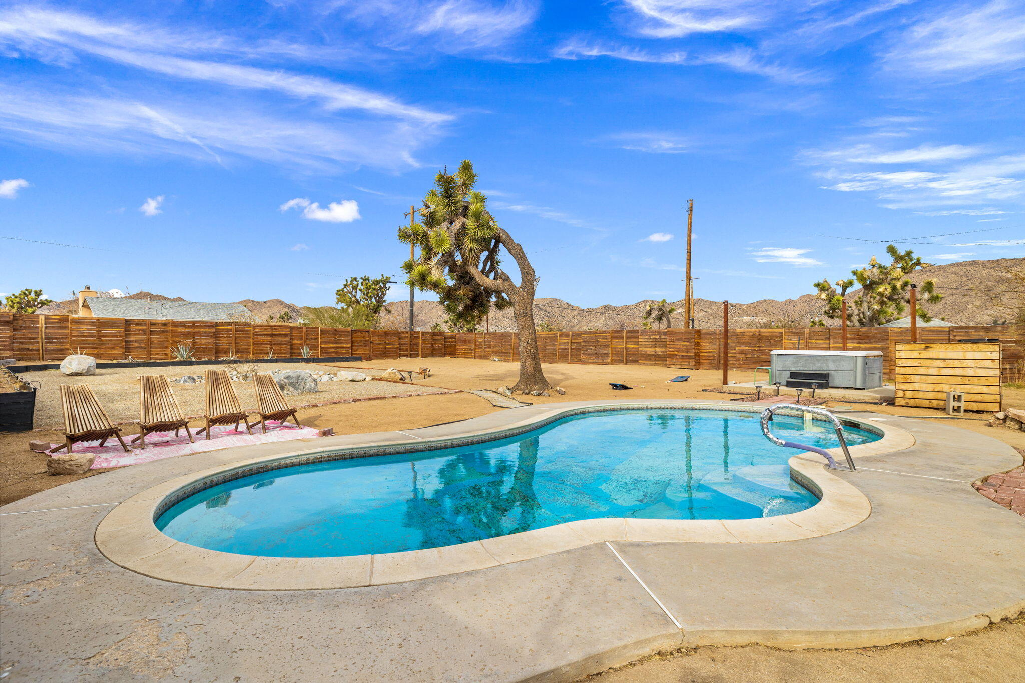 7552 Elk Trail Yucca Valley, CA 92284 - Photo 33 of 48 a view of a swimming pool with a lounge chair