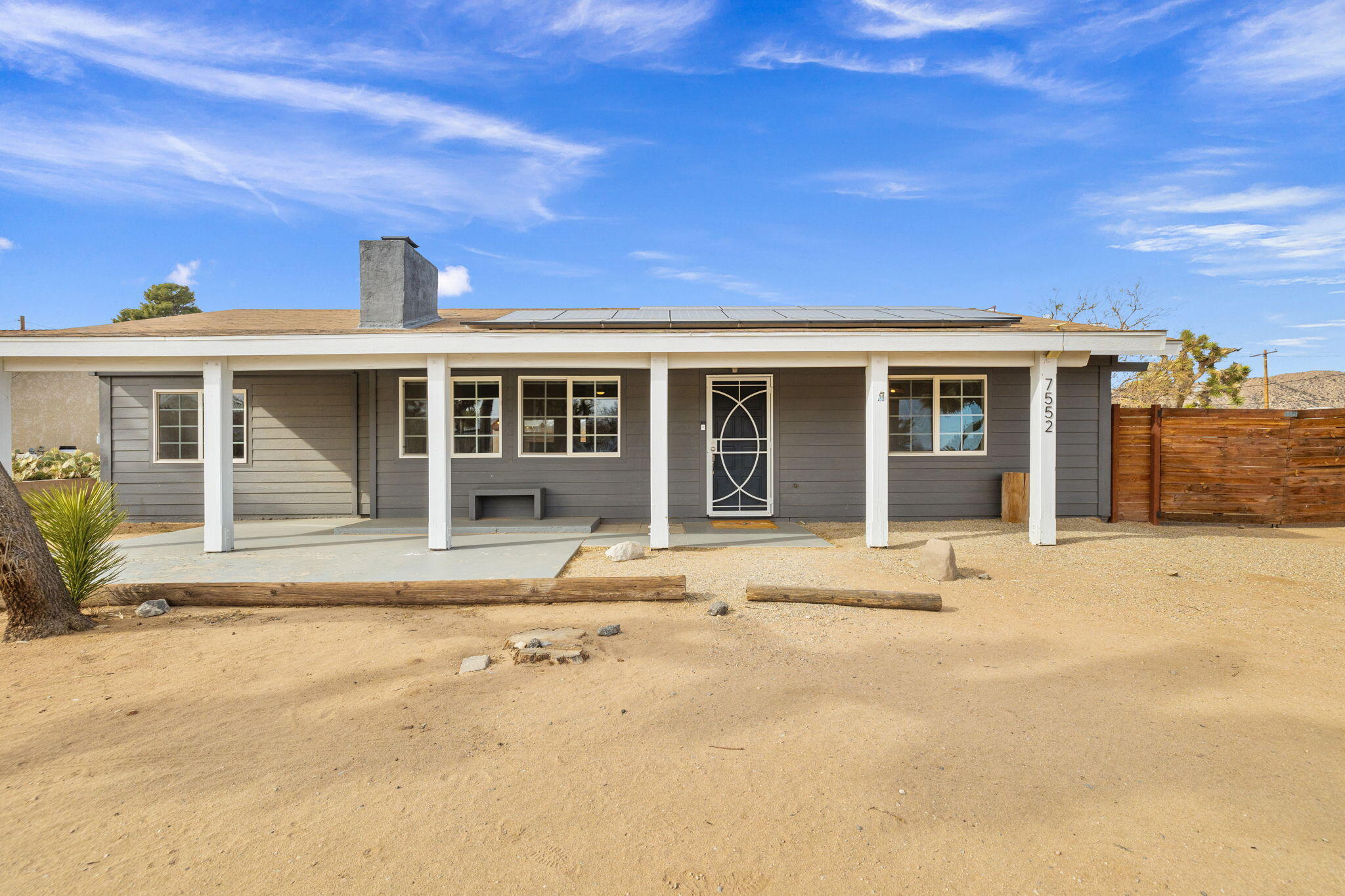 7552 Elk Trail Yucca Valley, CA 92284 - Photo 4 of 48 a front view of a house with a yard