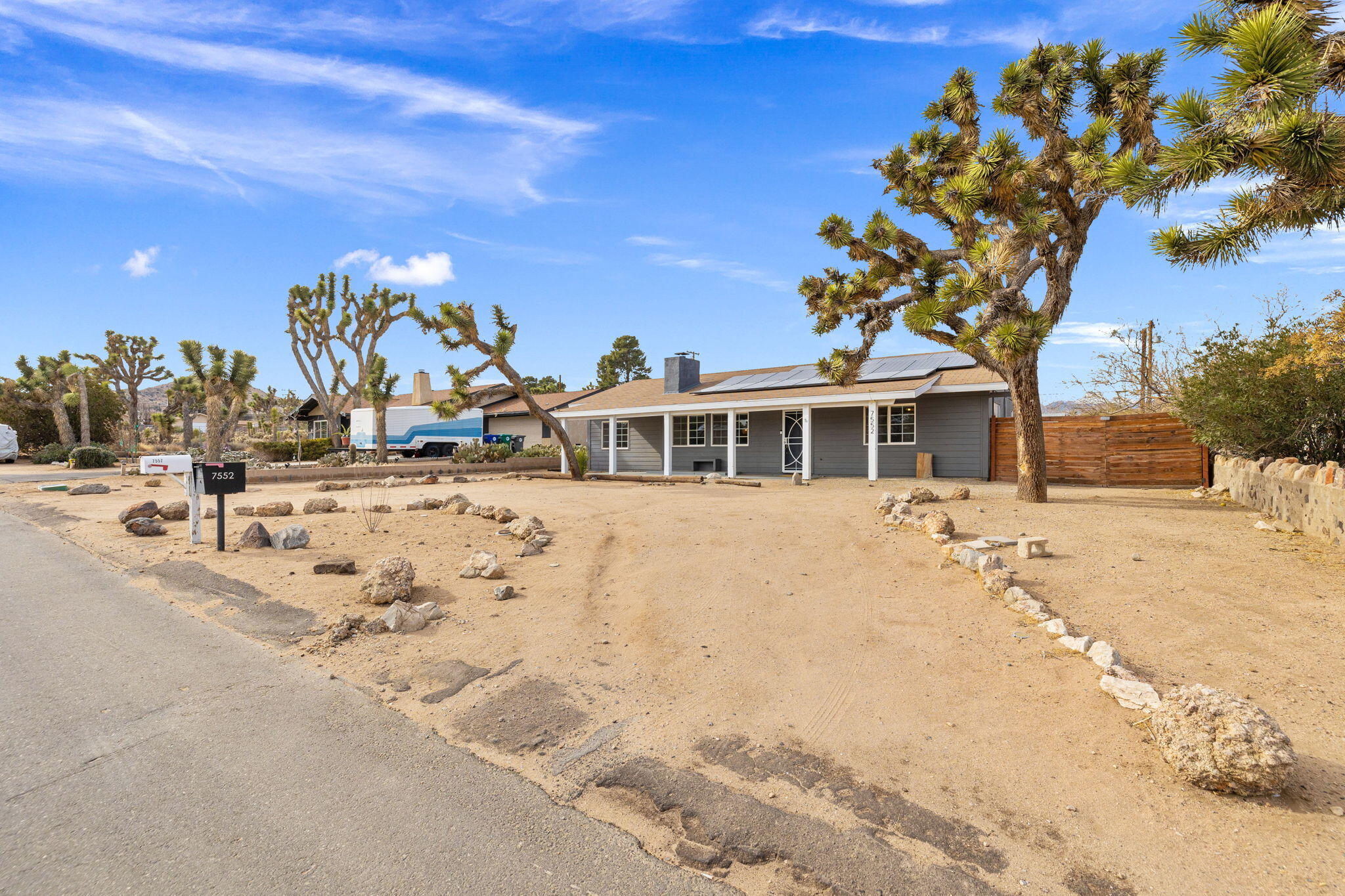 7552 Elk Trail Yucca Valley, CA 92284 - Photo 43 of 48 a front view of a house with a yard covered with snow