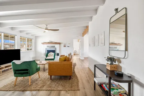 a living room with fireplace furniture and a window