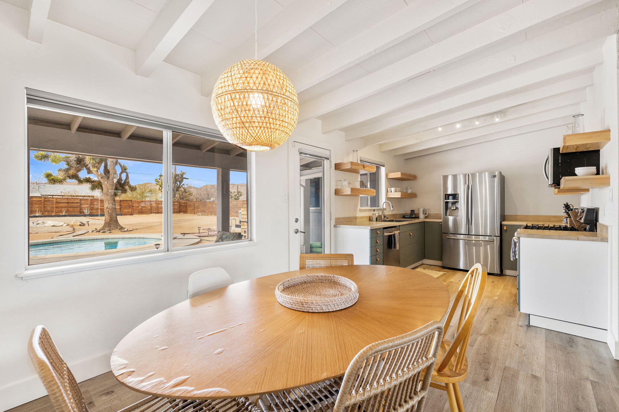 7552 Elk Trail Yucca Valley, CA 92284 - Photo 8 of 48 a view of a dining room with furniture a chandelier and wooden floor
