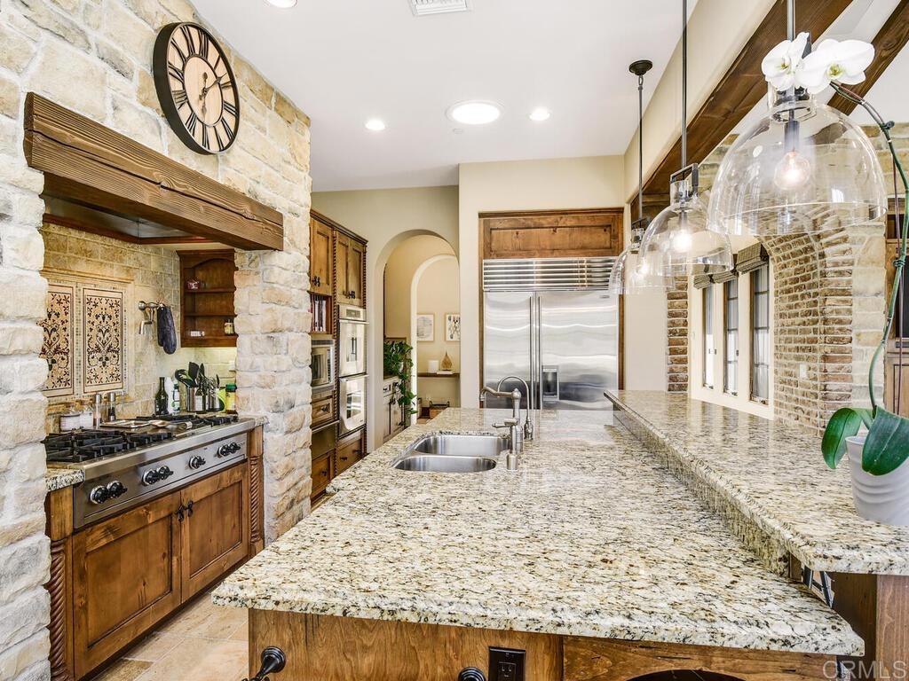 4272 Via Ravello Rancho Santa Fe, CA 92091 - Photo 13 of 38 a large kitchen with stainless steel appliances granite countertop a stove and a wooden cabinets
