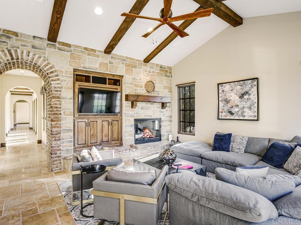 4272 Via Ravello Rancho Santa Fe, CA 92091 - Photo 14 of 38 a living room with furniture a flat screen tv and a fireplace
