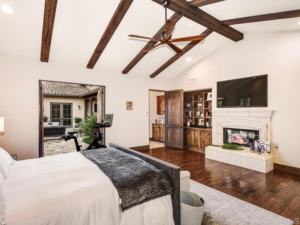 4272 Via Ravello Rancho Santa Fe, CA 92091 - Photo 17 of 38 a bedroom with furniture and a fireplace