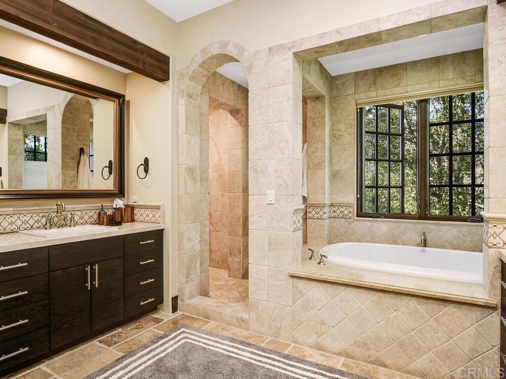 4272 Via Ravello Rancho Santa Fe, CA 92091 - Photo 19 of 38 a bathroom with a tub sink and mirror