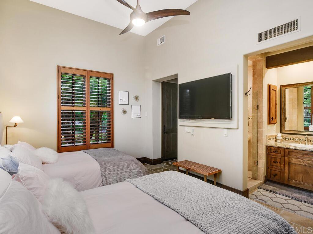4272 Via Ravello Rancho Santa Fe, CA 92091 - Photo 23 of 38 a bedroom with a bed and a television