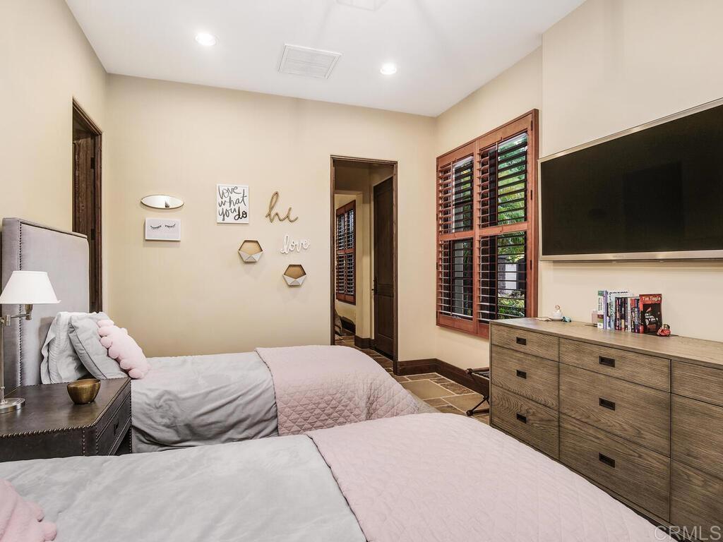 4272 Via Ravello Rancho Santa Fe, CA 92091 - Photo 24 of 38 a bedroom with a large bed and a flat screen tv