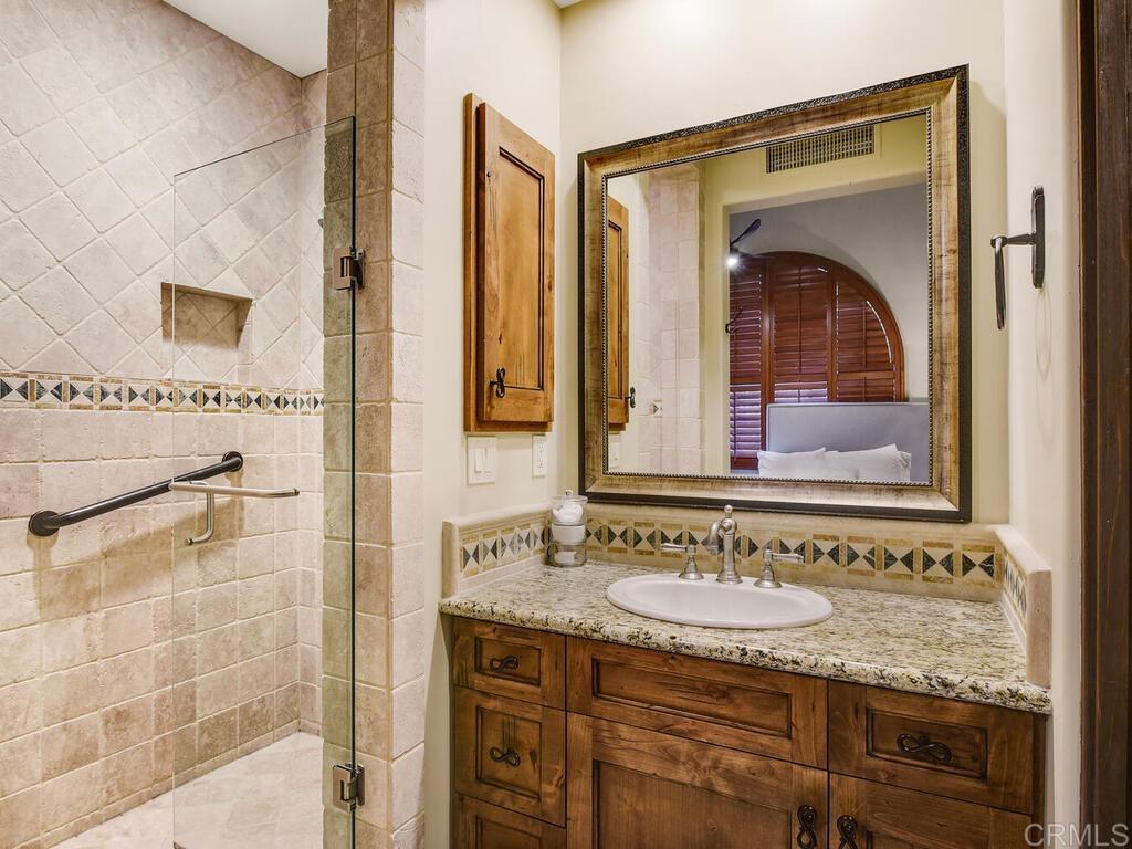 4272 Via Ravello Rancho Santa Fe, CA 92091 - Photo 25 of 38 a bathroom with a granite countertop sink and mirror