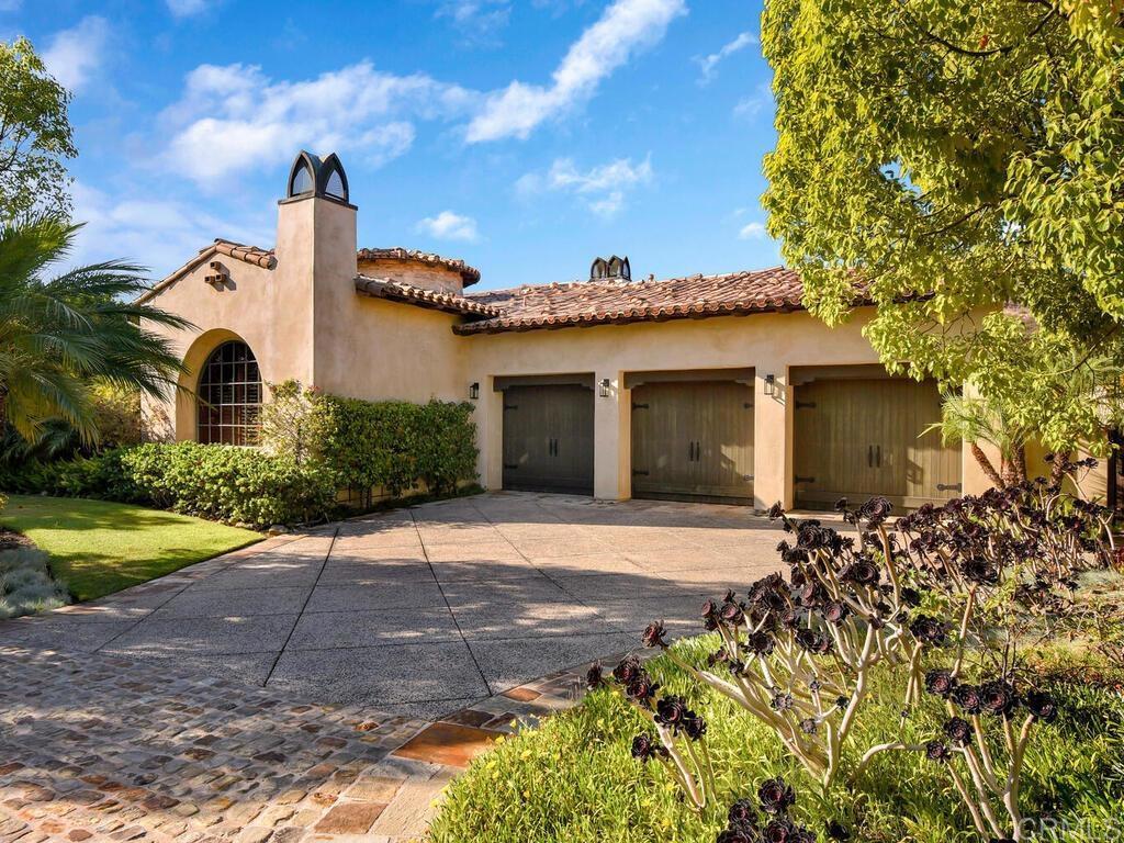 4272 Via Ravello Rancho Santa Fe, CA 92091 - Photo 28 of 38 a front view of a house with a yard and garage