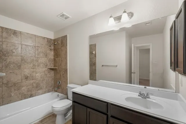 a bathroom with a bathtub and shower
