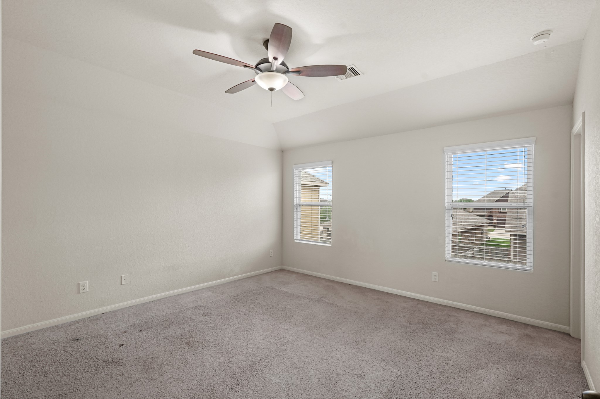 3215 Upland Spring Trace Katy, TX 77493 - Photo 19 of 24 an empty room with windows and fan