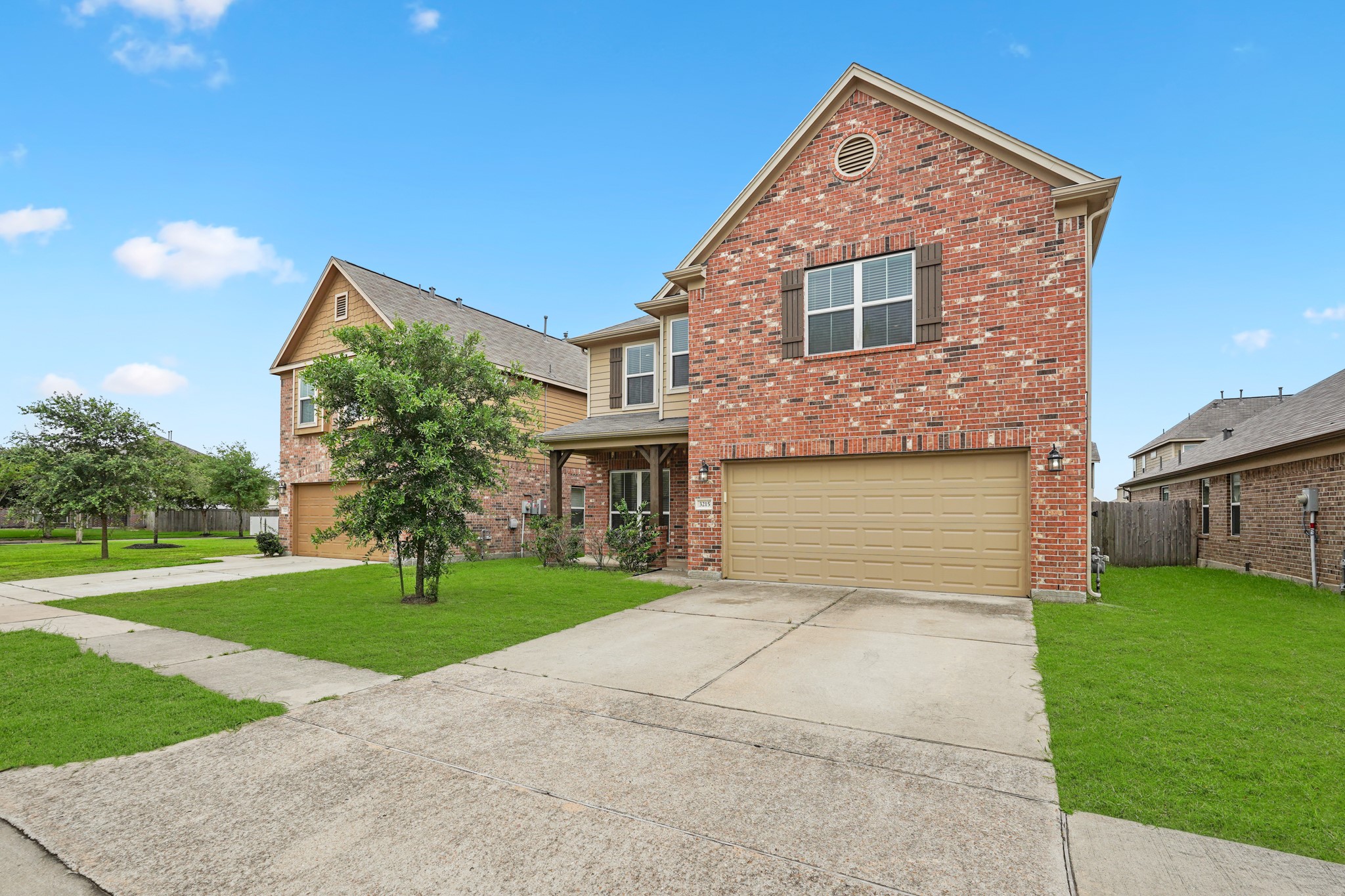 3215 Upland Spring Trace Katy, TX 77493 - Photo 2 of 24 a front view of a house with a garden and yard