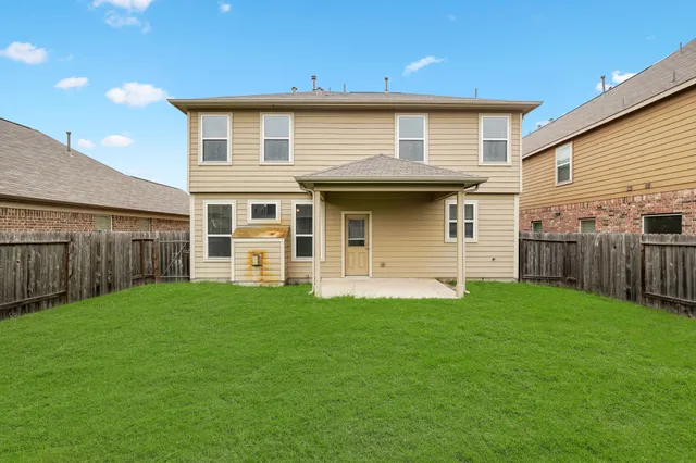 a view of a house with backyard and entertaining space