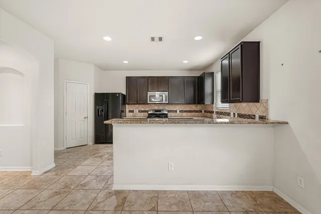 a view of a kitchen with a stove cabinets and wooden floor