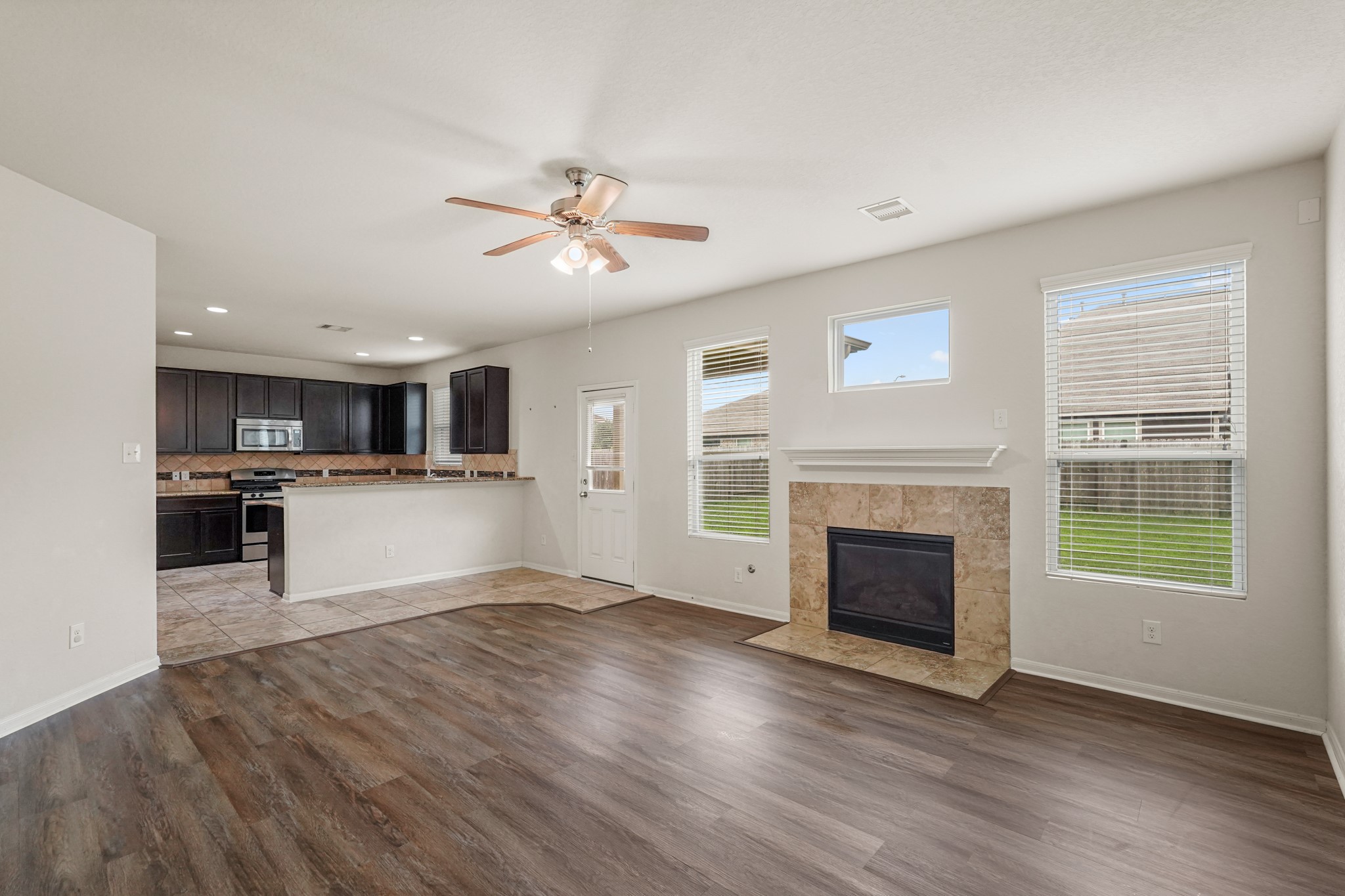 3215 Upland Spring Trace Katy, TX 77493 - Photo 10 of 24 a view of a kitchen with a stove cabinets and wooden floor