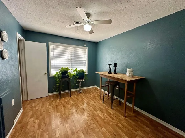 a workspace room with furniture and wooden floor
