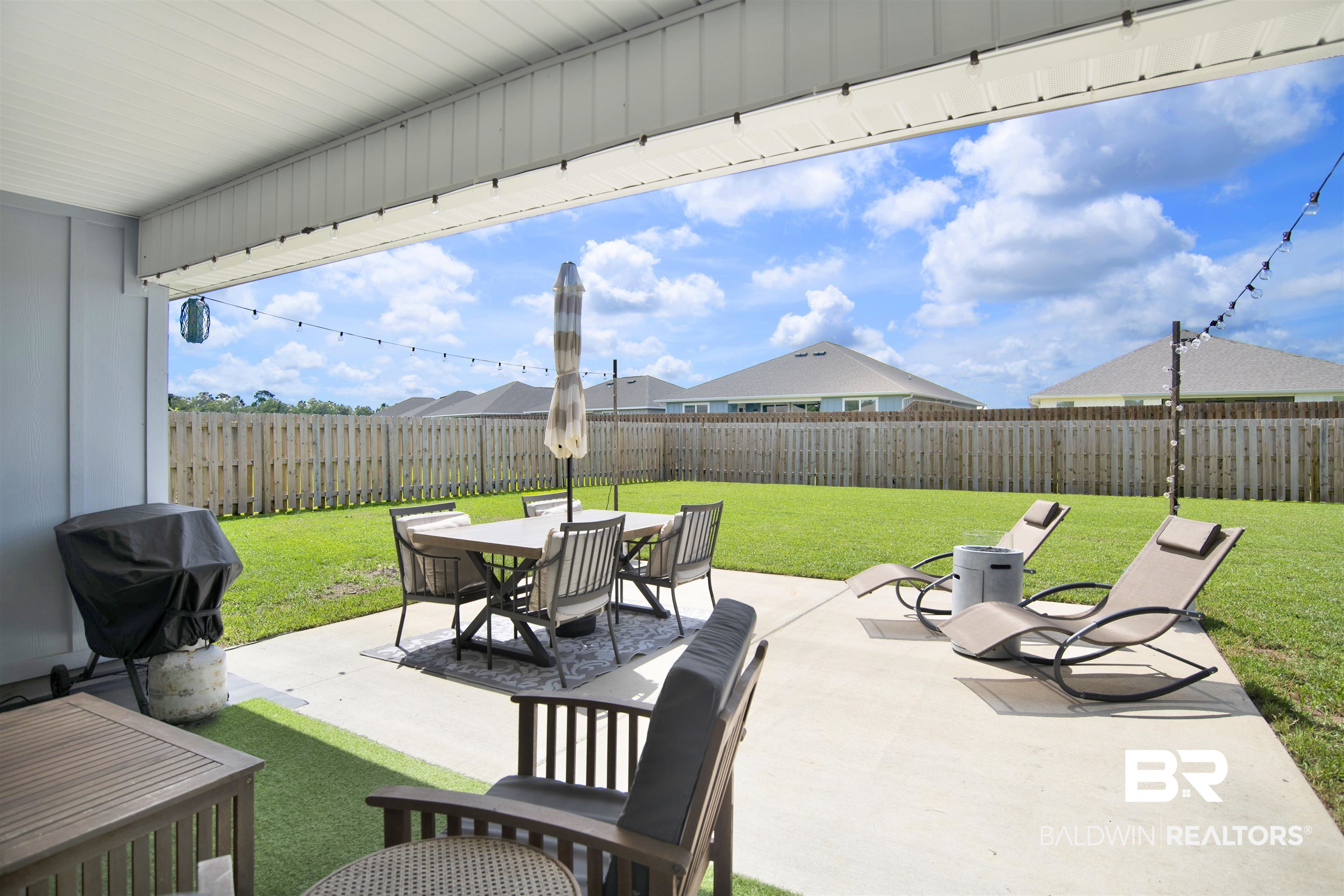 22301 Early Dawn Circle Foley, AL 36535 - Photo 32 of 45 Covered patio with string lighting and a concrete slab