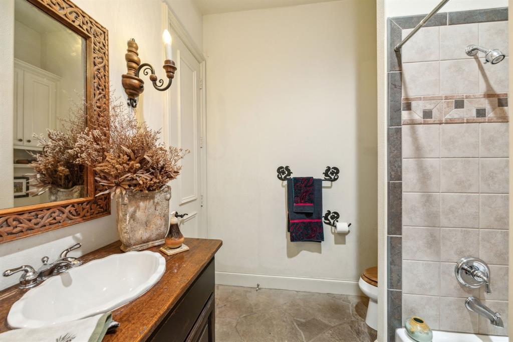 868 English Road Rockwall, TX 75032 - Photo 18 of 37 a bathroom with a sink and mirror