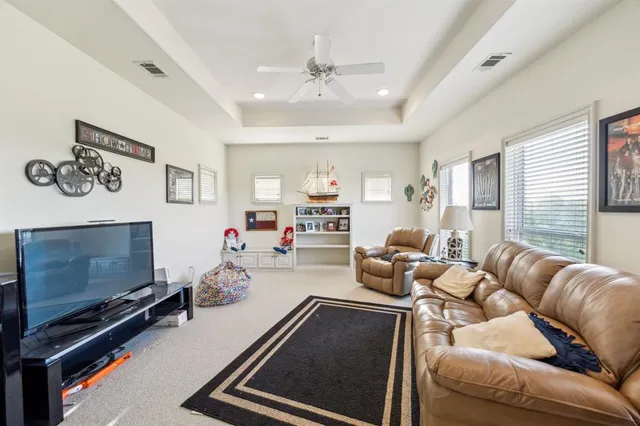 a room with furniture a flat screen tv and a fireplace