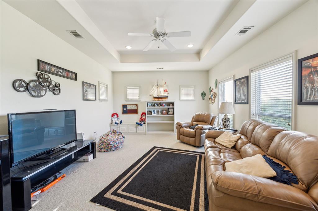 868 English Road Rockwall, TX 75032 - Photo 21 of 37 a room with furniture a flat screen tv and a fireplace