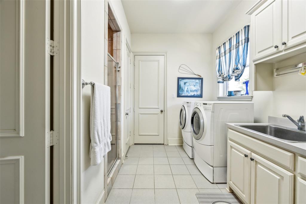 868 English Road Rockwall, TX 75032 - Photo 22 of 37 a bathroom with a sink a washer and dryer