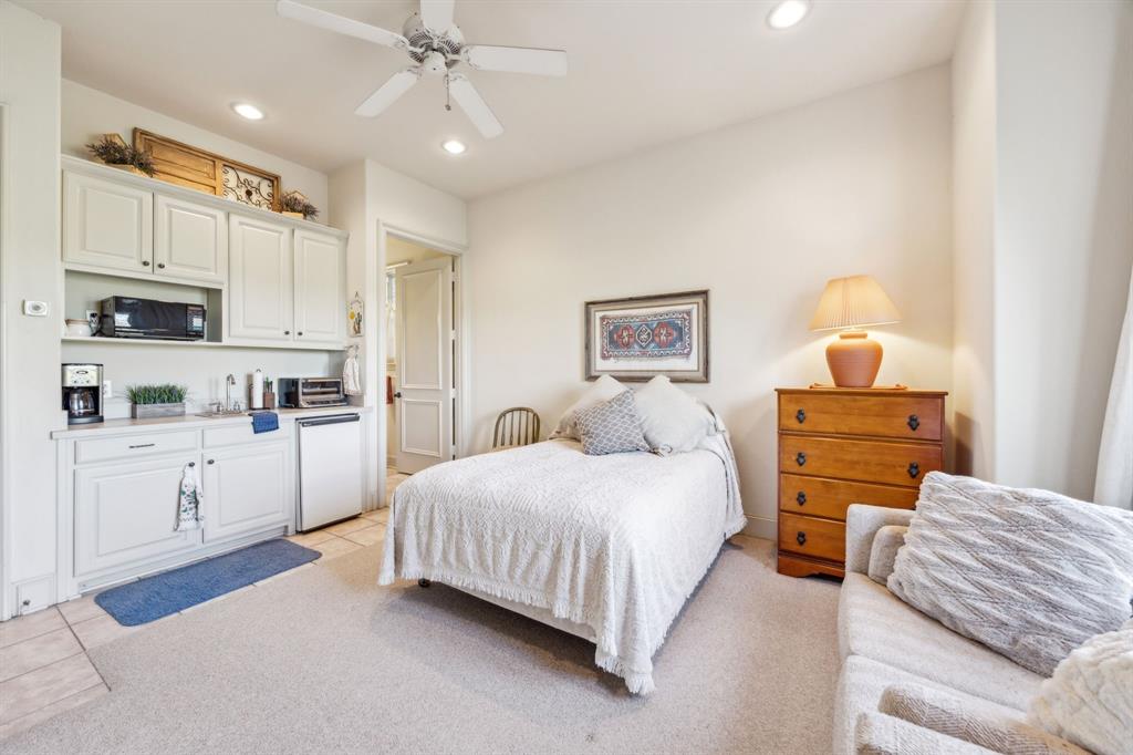 868 English Road Rockwall, TX 75032 - Photo 23 of 37 a bedroom with a bed and a chandelier