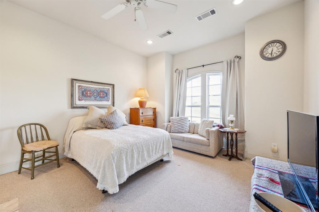 868 English Road Rockwall, TX 75032 - Photo 24 of 37 a bedroom with a bed and a couch