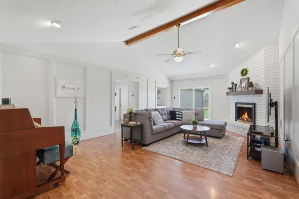 a living room with furniture and a fireplace