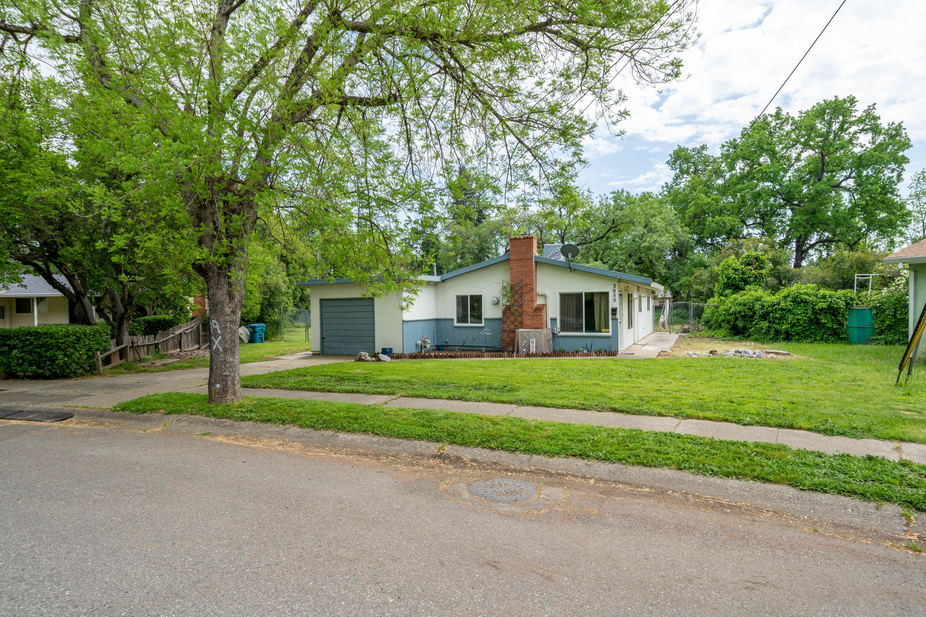 3055 Sharon Avenue Anderson, CA 96007 - Photo 1 of 52 a front view of a house with a yard and garage