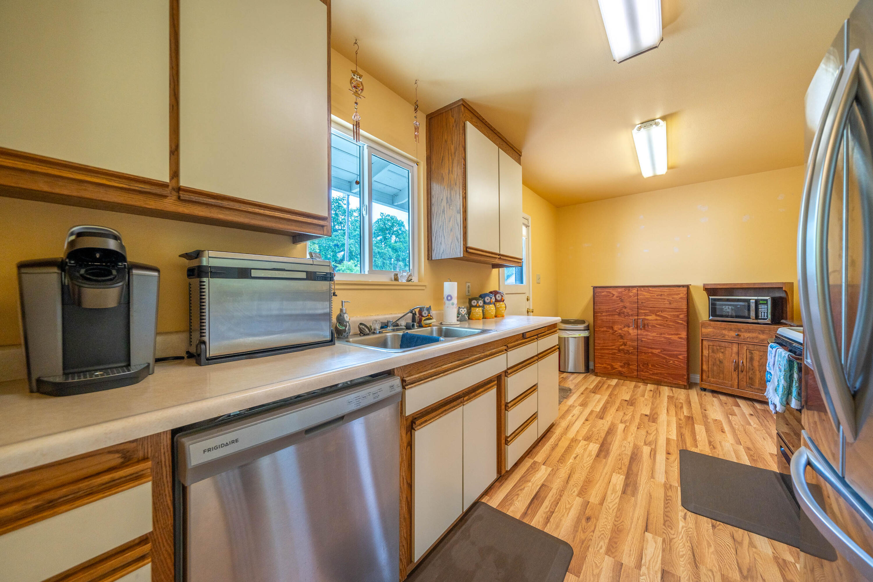 3055 Sharon Avenue Anderson, CA 96007 - Photo 16 of 52 a kitchen with stainless steel appliances granite countertop a sink and wooden floor