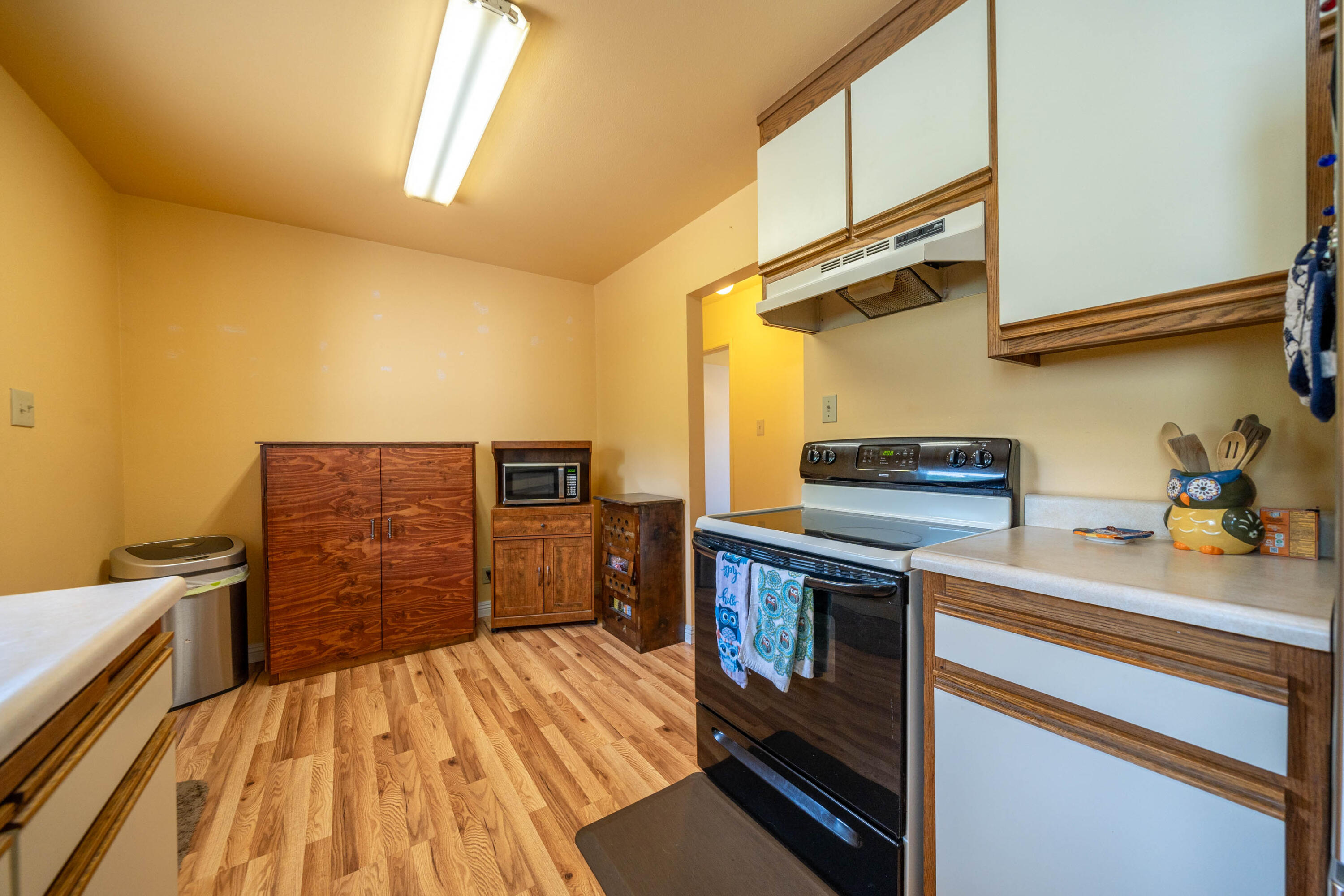 3055 Sharon Avenue Anderson, CA 96007 - Photo 17 of 52 a kitchen with cabinets and wooden floor