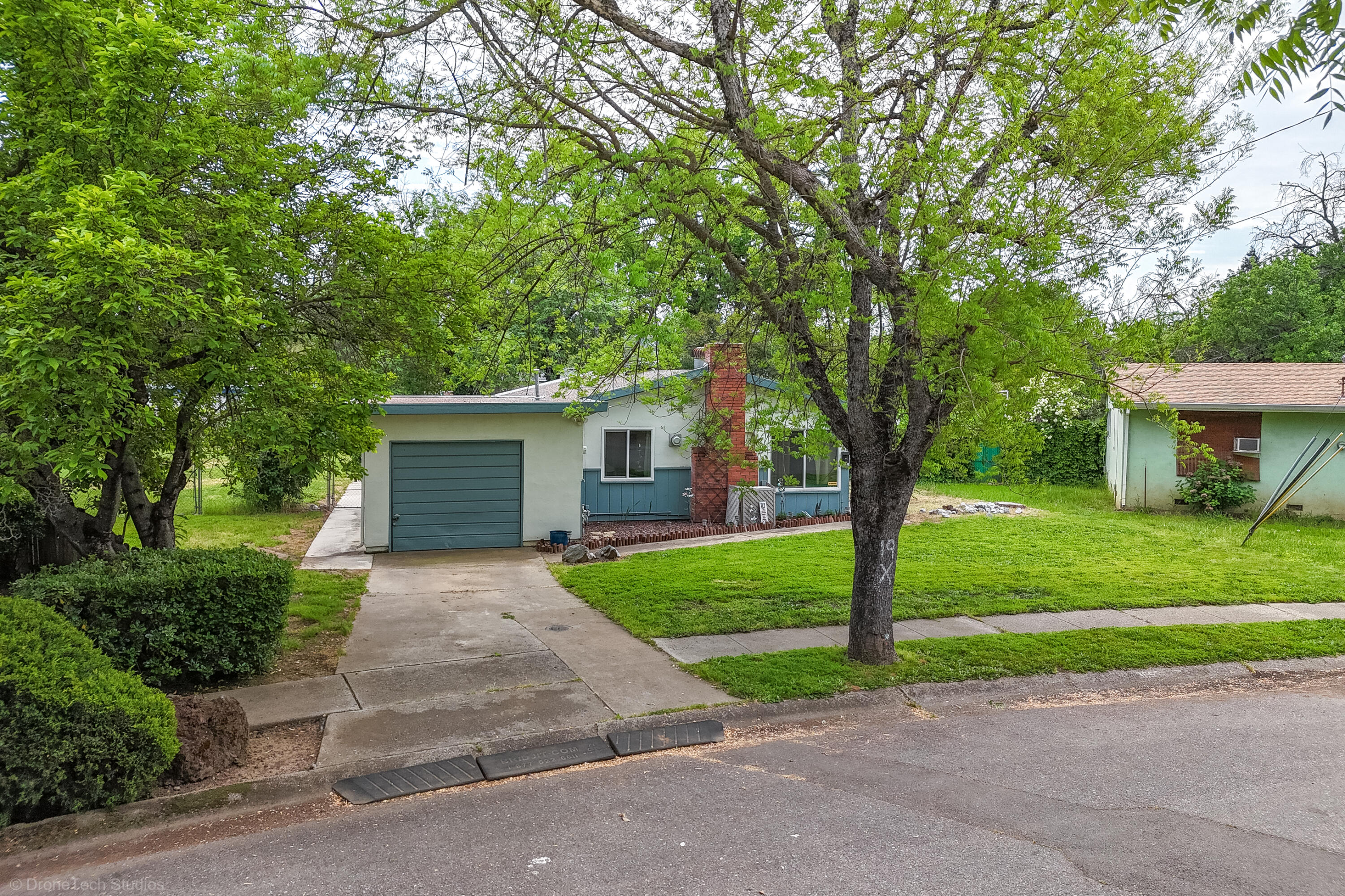 3055 Sharon Avenue Anderson, CA 96007 - Photo 41 of 52 a front view of a house with a garden and trees