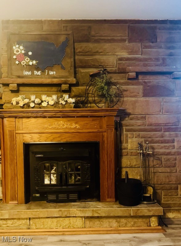 2675 Seifert-Lewis Road Hubbard, OH 44425 - Photo 19 of 38 Detailed view of wood finished floors and a wood stove