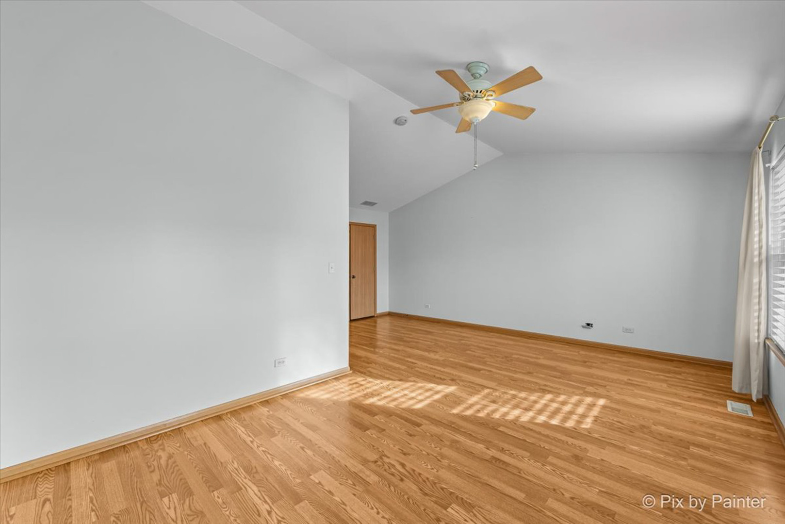 2466 Amber Lane Elgin, IL 60123 - Photo 13 of 32 a view of a room with wooden floor and a ceiling fan