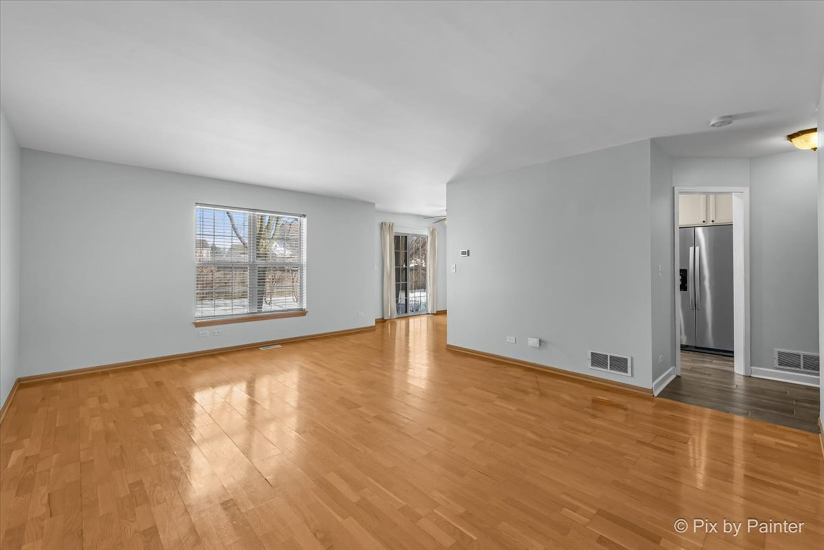 2466 Amber Lane Elgin, IL 60123 - Photo 14 of 32 an empty room with wooden floor and windows