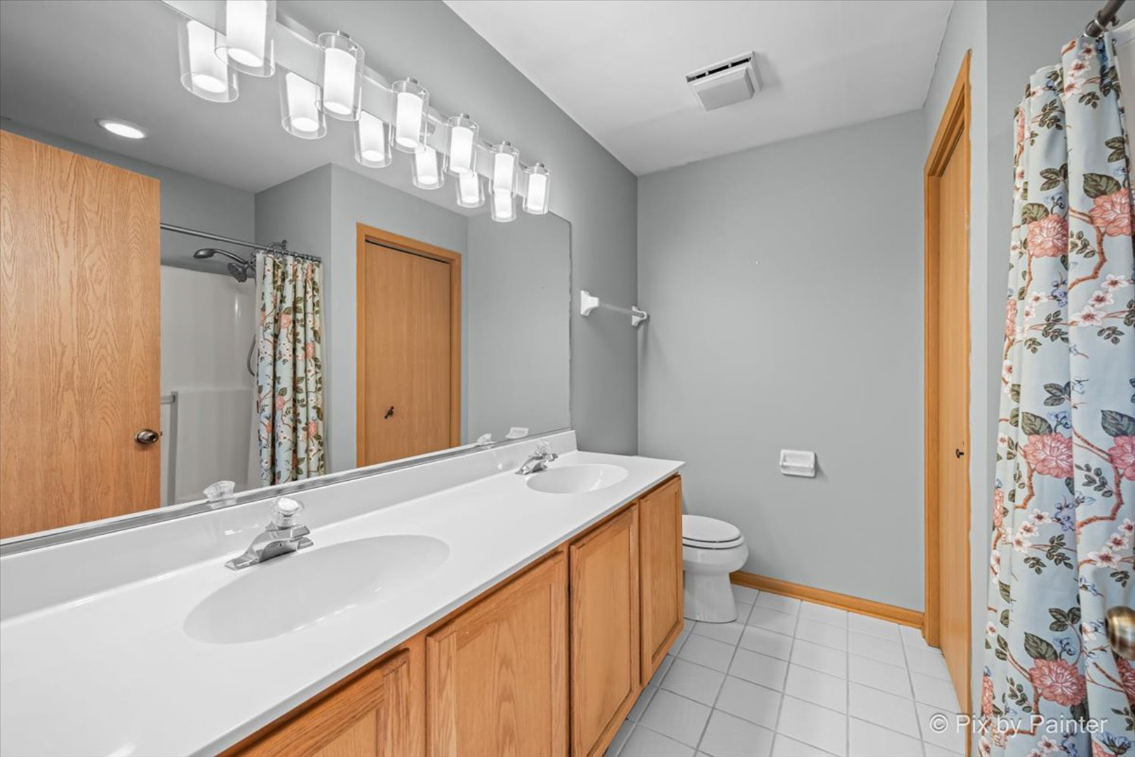 2466 Amber Lane Elgin, IL 60123 - Photo 15 of 32 a bathroom with a sink a toilet a mirror a vanity and shower