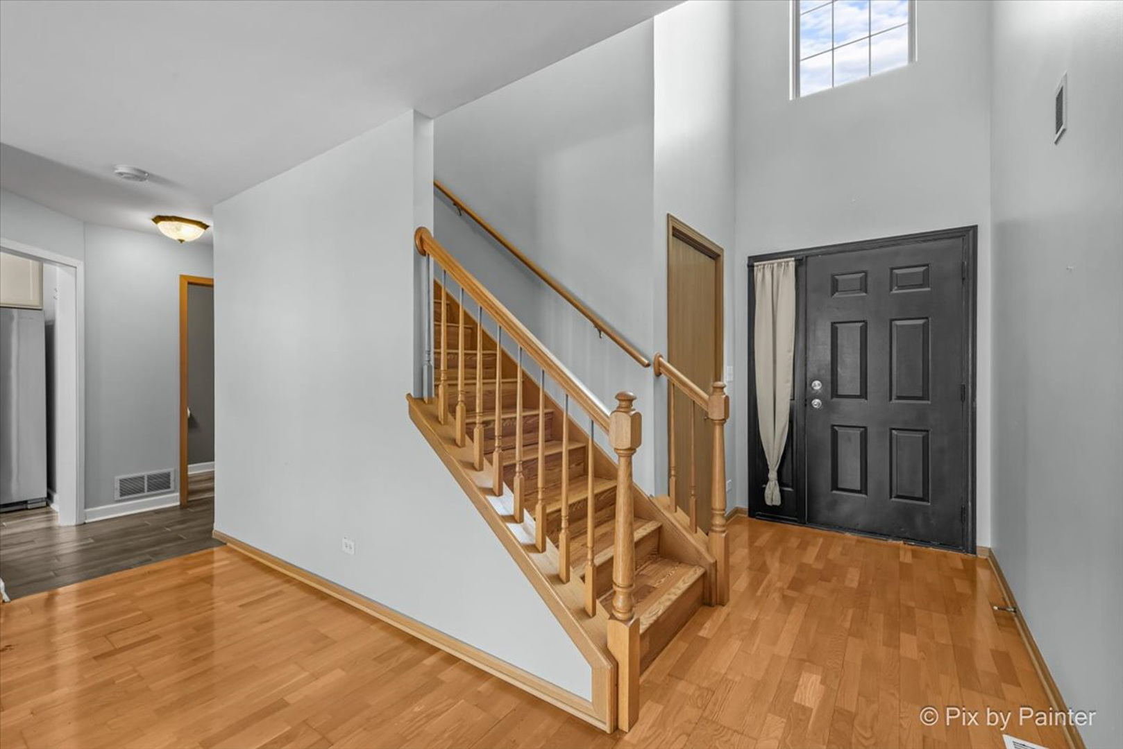 2466 Amber Lane Elgin, IL 60123 - Photo 2 of 32 a view of a hallway with wooden floor and staircase