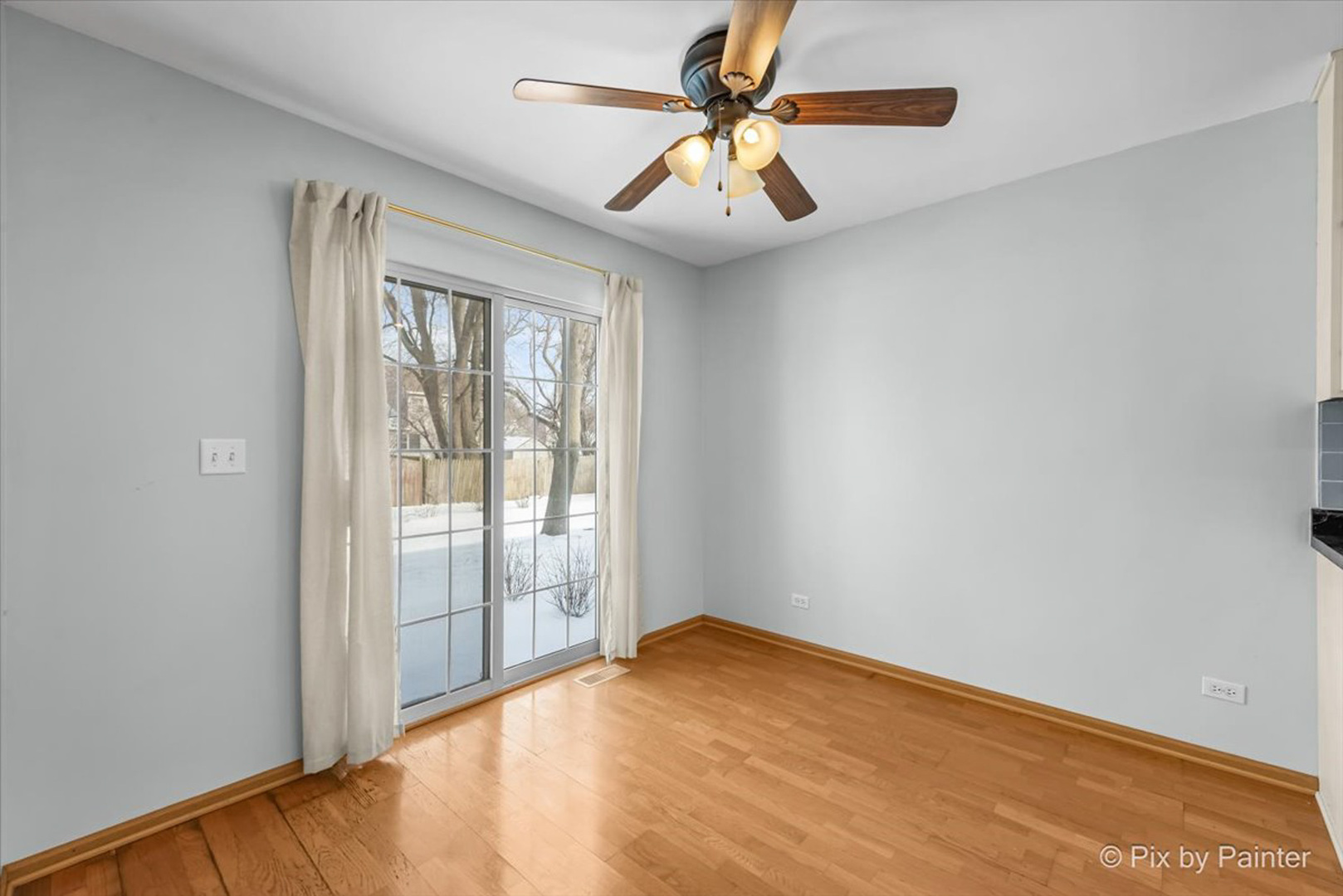 2466 Amber Lane Elgin, IL 60123 - Photo 5 of 32 an empty room with windows and fan