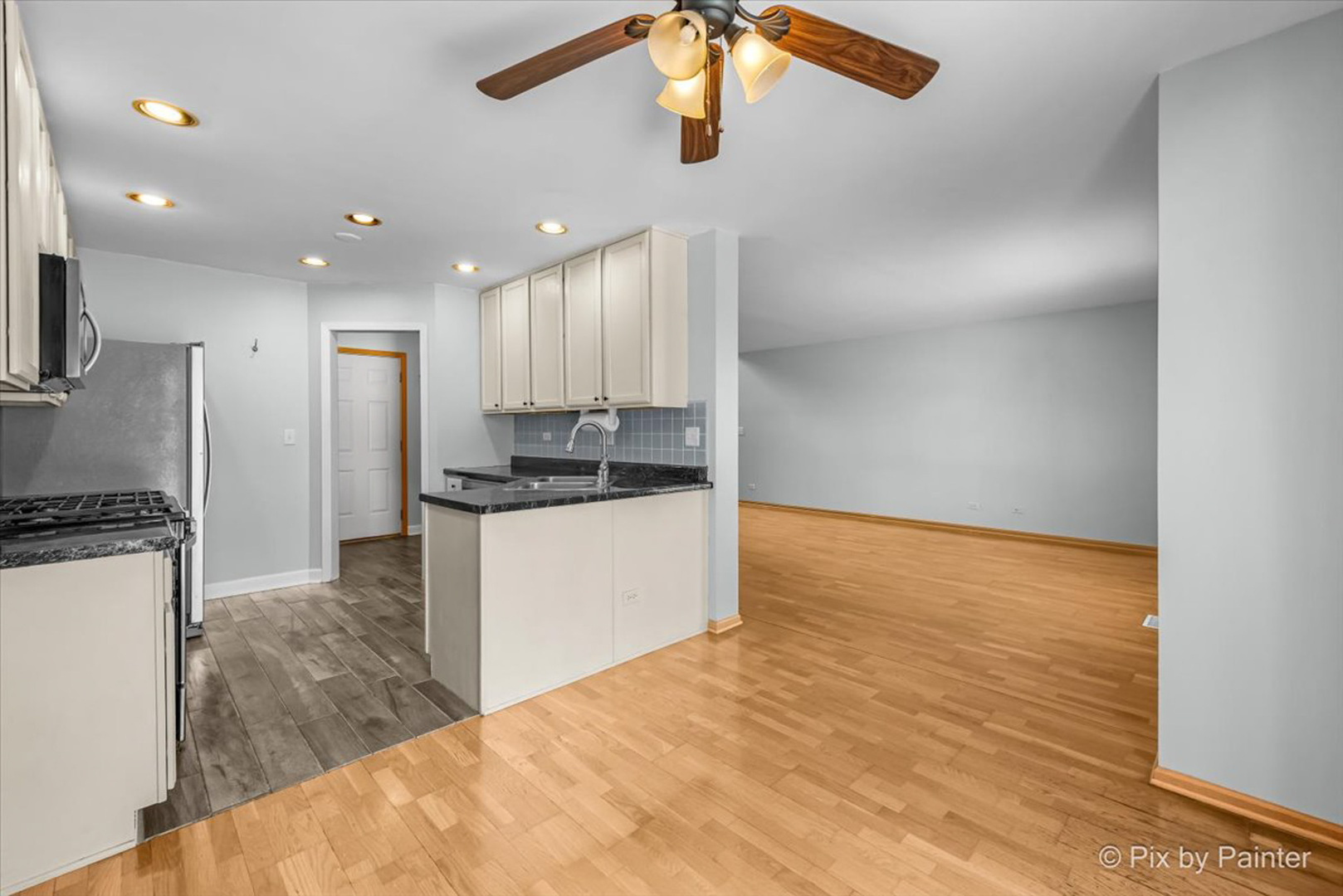 2466 Amber Lane Elgin, IL 60123 - Photo 6 of 32 a kitchen with kitchen island a sink stainless steel appliances and counter space