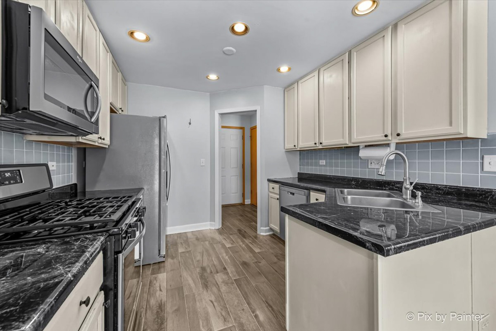 2466 Amber Lane Elgin, IL 60123 - Photo 7 of 32 a kitchen with granite countertop a sink stove and refrigerator