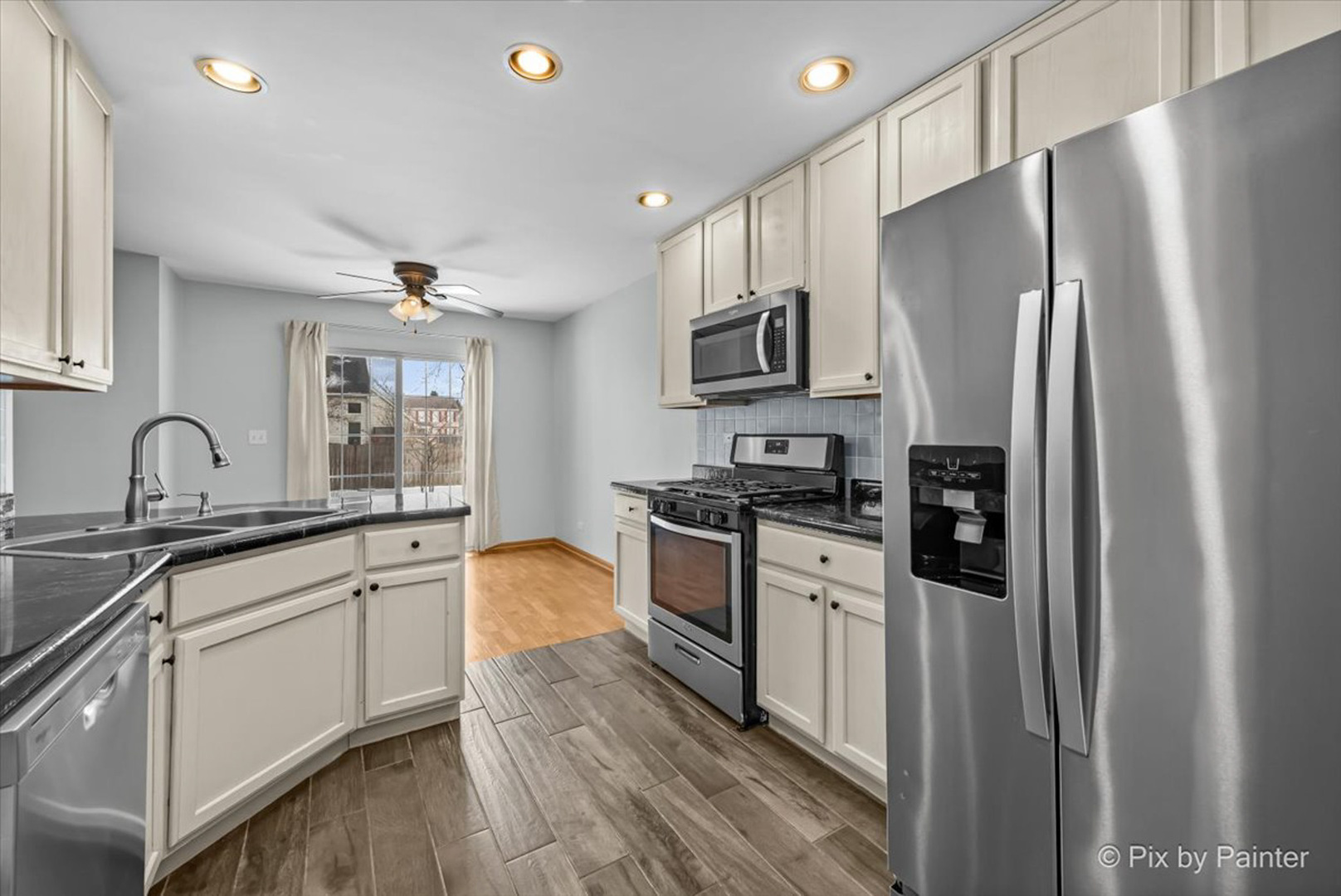 2466 Amber Lane Elgin, IL 60123 - Photo 8 of 32 a kitchen with stainless steel appliances granite countertop a refrigerator sink and stove
