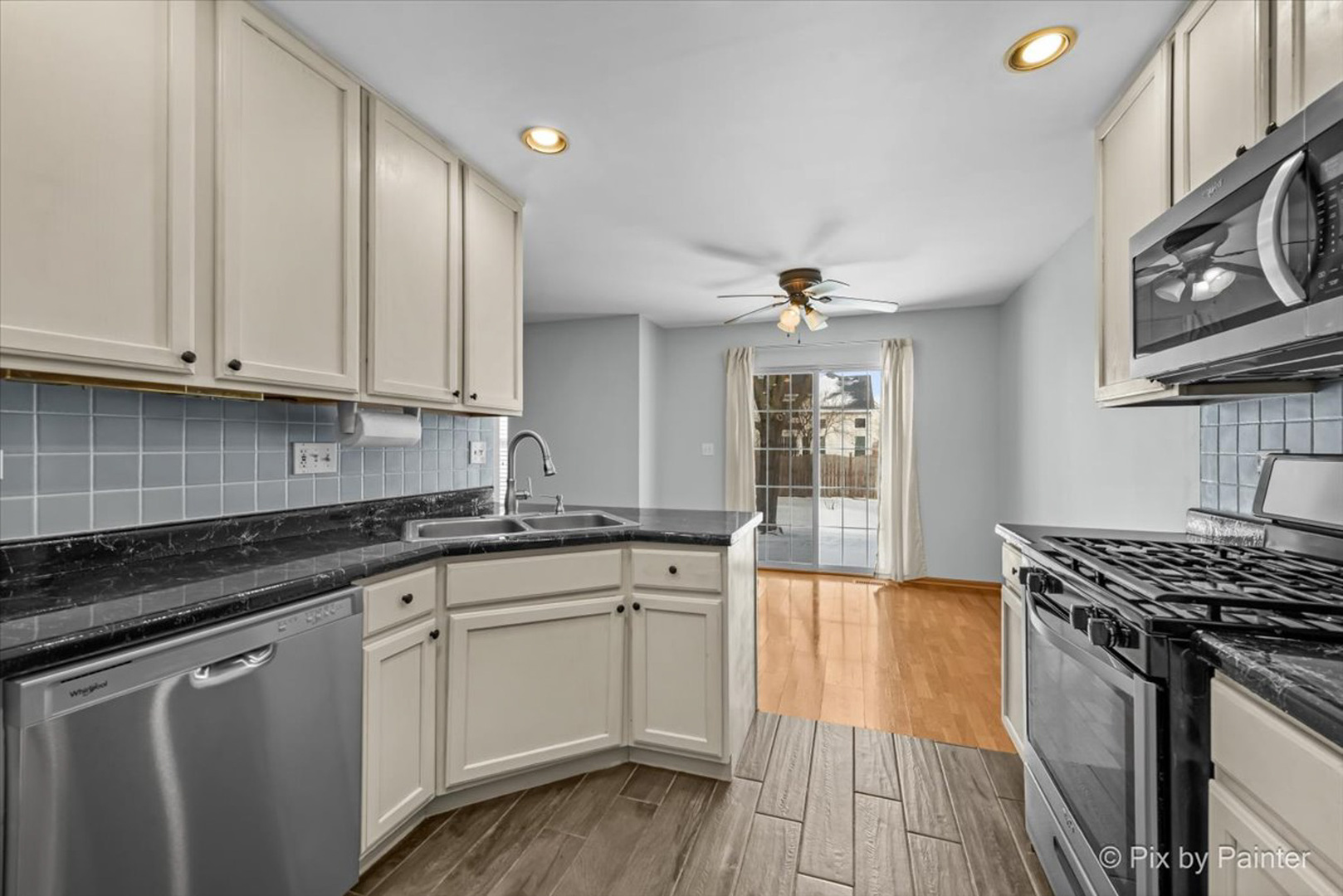2466 Amber Lane Elgin, IL 60123 - Photo 9 of 32 a kitchen with stainless steel appliances granite countertop a sink stove and cabinets