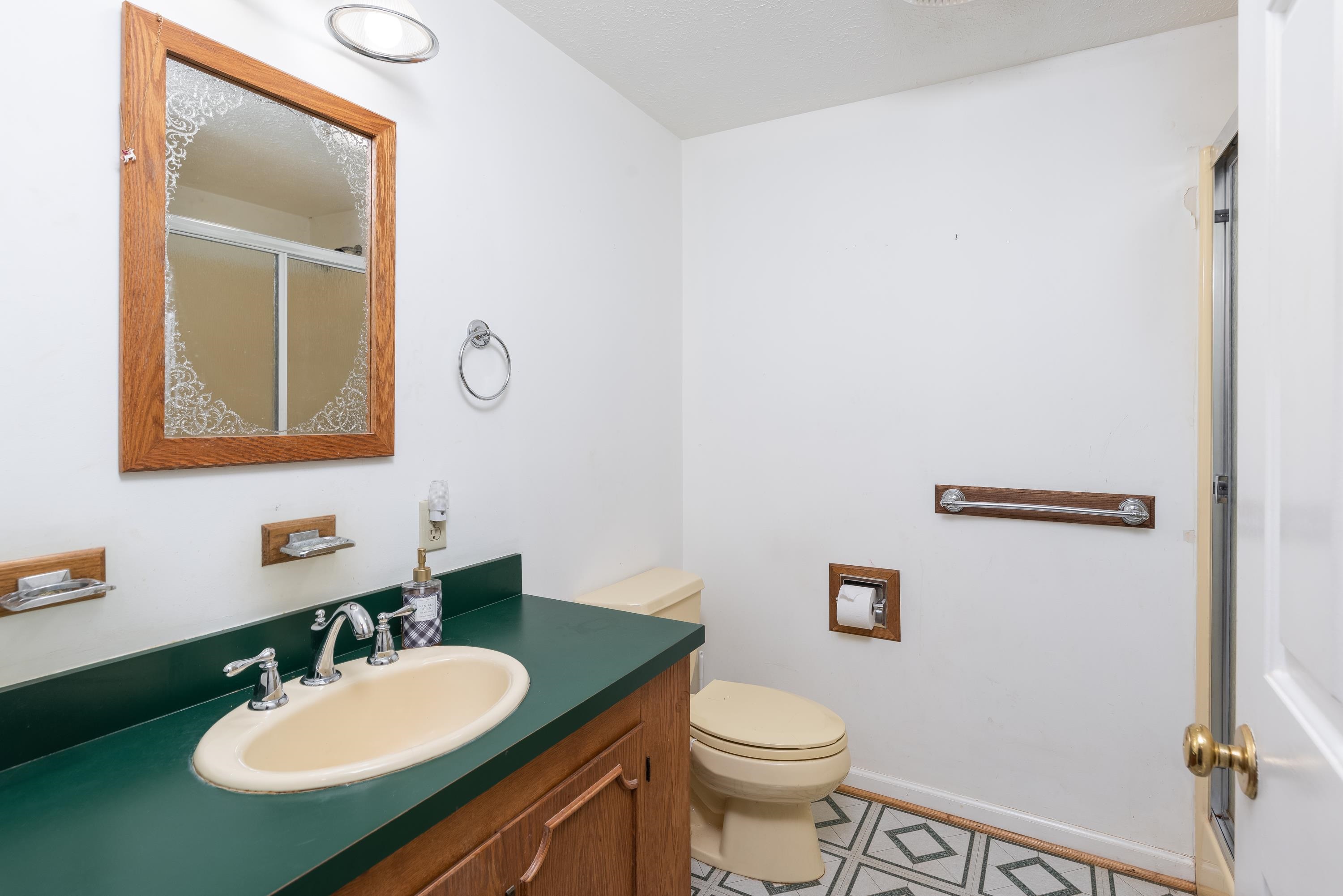 7582 Plank Road Afton, VA 22920 - Photo 36 of 50 a bathroom with a toilet sink mirror and vanity